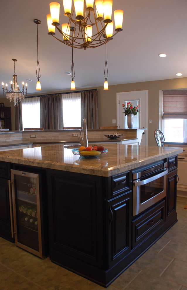 Mid-sized transitional u-shaped ceramic tile open concept kitchen photo in Denver with an undermount sink, raised-panel cabinets, white cabinets, quartz countertops, beige backsplash, matchstick tile backsplash, stainless steel appliances and an island