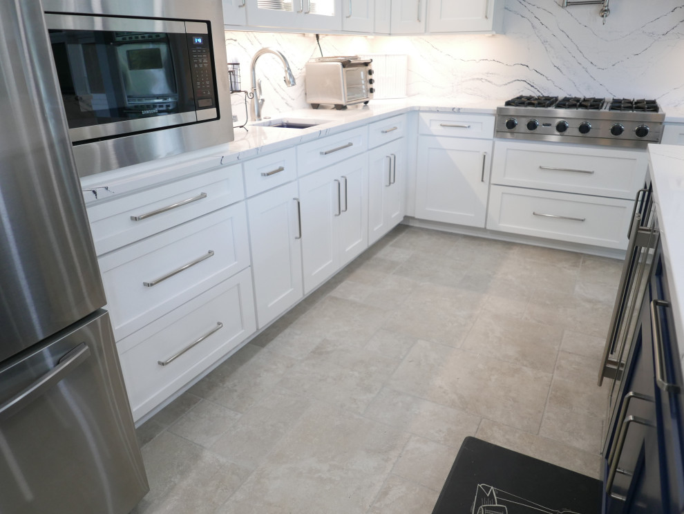Design ideas for a large classic u-shaped open plan kitchen in Other with a submerged sink, shaker cabinets, white cabinets, engineered stone countertops, white splashback, engineered quartz splashback, stainless steel appliances, porcelain flooring, an island, grey floors and white worktops.