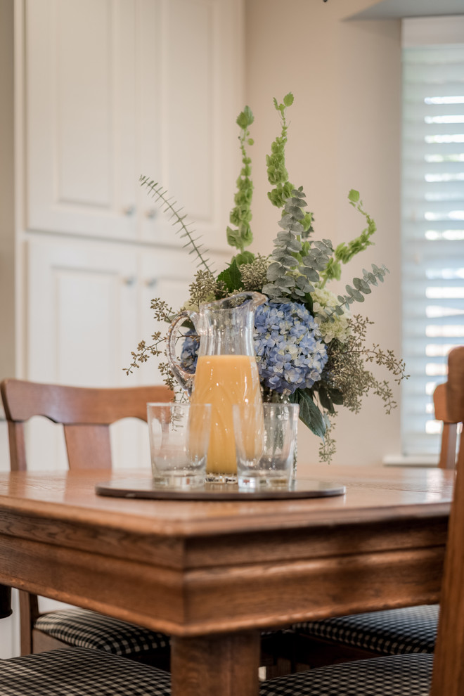 Enclosed kitchen - mid-sized transitional galley medium tone wood floor enclosed kitchen idea in Dallas with an undermount sink, raised-panel cabinets, white cabinets, granite countertops, white backsplash, subway tile backsplash, stainless steel appliances and a peninsula