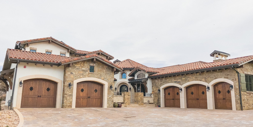 This is an example of a large traditional detached four-car garage in Denver.