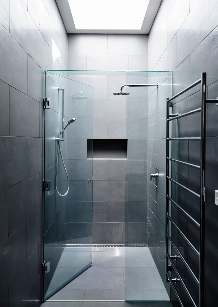 Inspiration for a mid-sized contemporary master bathroom in Melbourne with dark wood cabinets, an undermount tub, an open shower, a one-piece toilet, gray tile, ceramic tile, grey walls, ceramic floors, an undermount sink, engineered quartz benchtops and a hinged shower door.