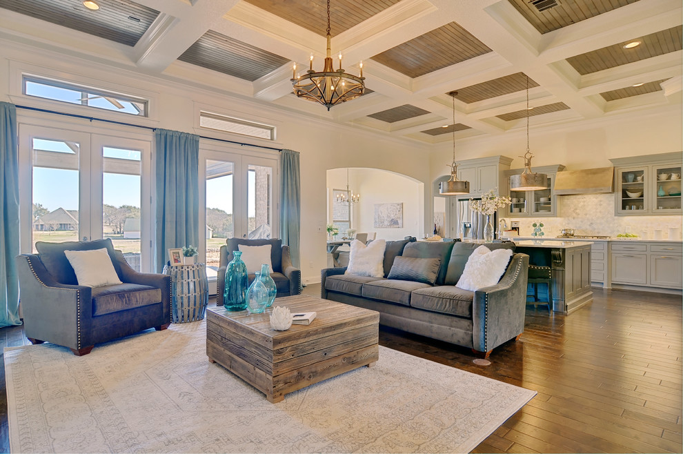 Design ideas for a large transitional open concept living room in Dallas with beige walls, medium hardwood floors, a standard fireplace, a stone fireplace surround and a wall-mounted tv.