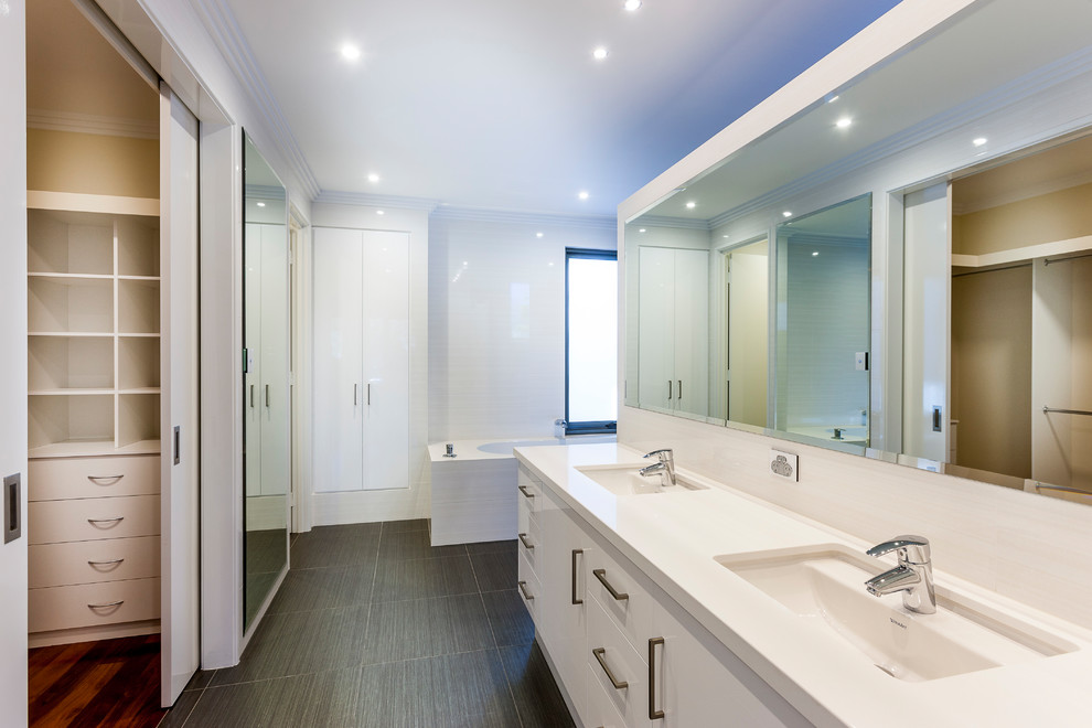 Mid-sized contemporary master bathroom in Perth with white cabinets, an undermount sink and engineered quartz benchtops.