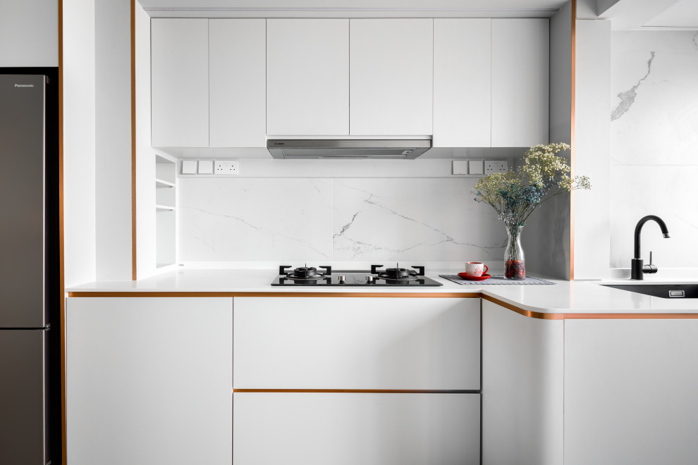Small contemporary l-shaped kitchen in Singapore with an undermount sink, flat-panel cabinets, white cabinets, white splashback and white benchtop.