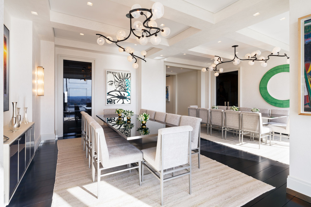 Expansive contemporary dining room in New York with white walls and dark hardwood floors.
