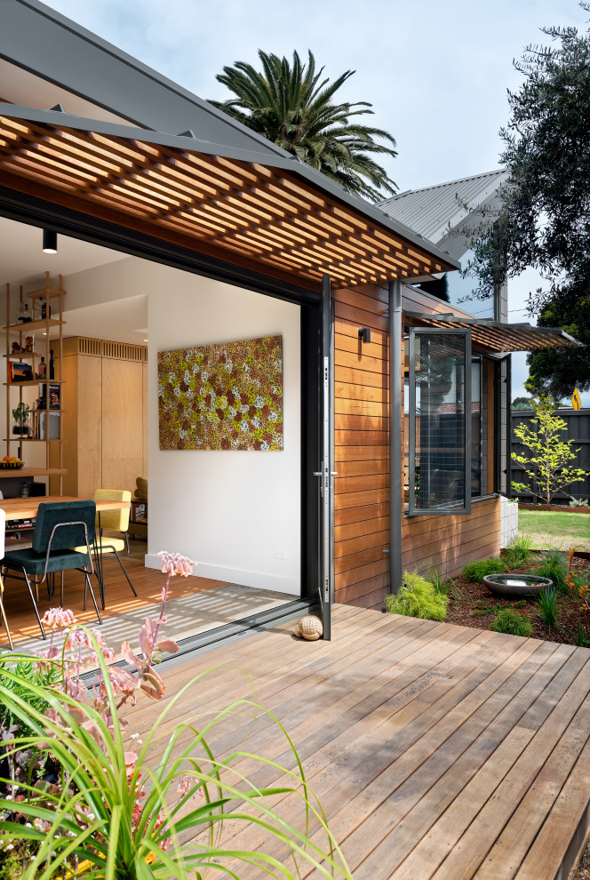 Photo of a small contemporary backyard deck in Melbourne with an awning.