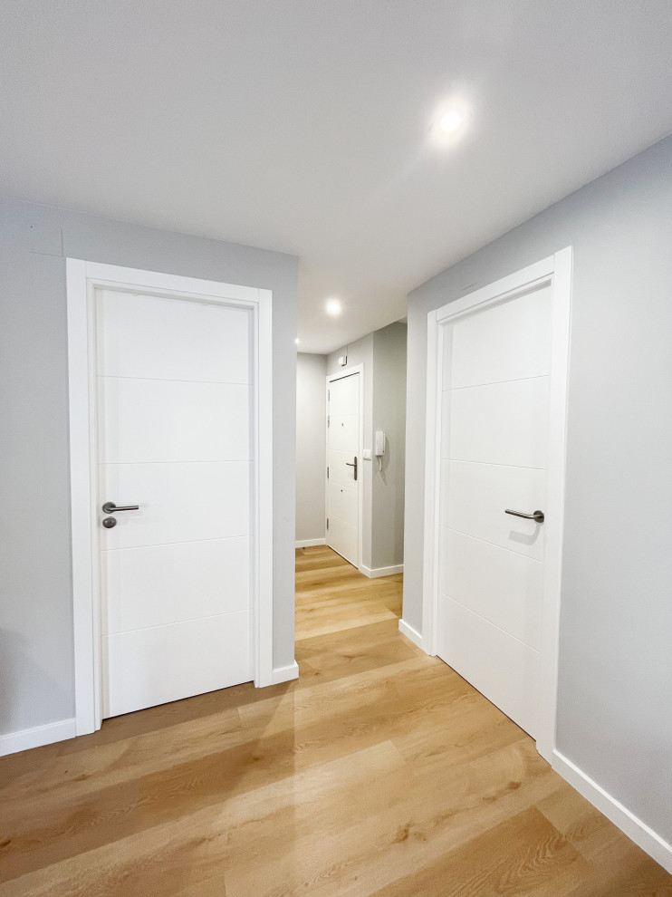 Design ideas for a small scandinavian hallway in Other with grey walls, vinyl floors and brown floor.