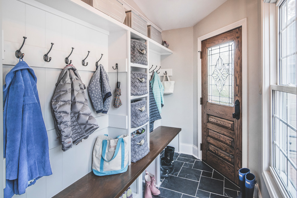 Photo of a small transitional mudroom in Columbus with grey walls, slate floors, a single front door and a dark wood front door.
