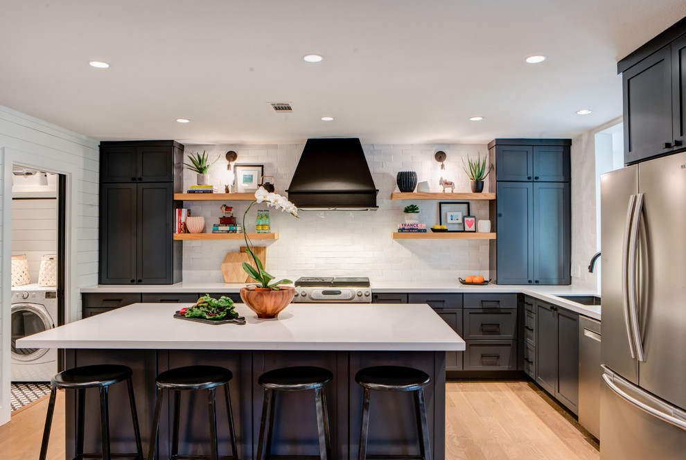 Inspiration for a mid-sized country kitchen in Austin with an undermount sink, shaker cabinets, blue cabinets, quartz benchtops, white splashback, terra-cotta splashback, stainless steel appliances, brown floor, white benchtop, with island and light hardwood floors.