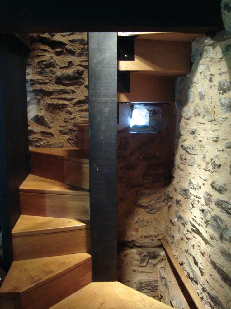 Photo of a small country wood spiral staircase in Toulouse with wood risers.