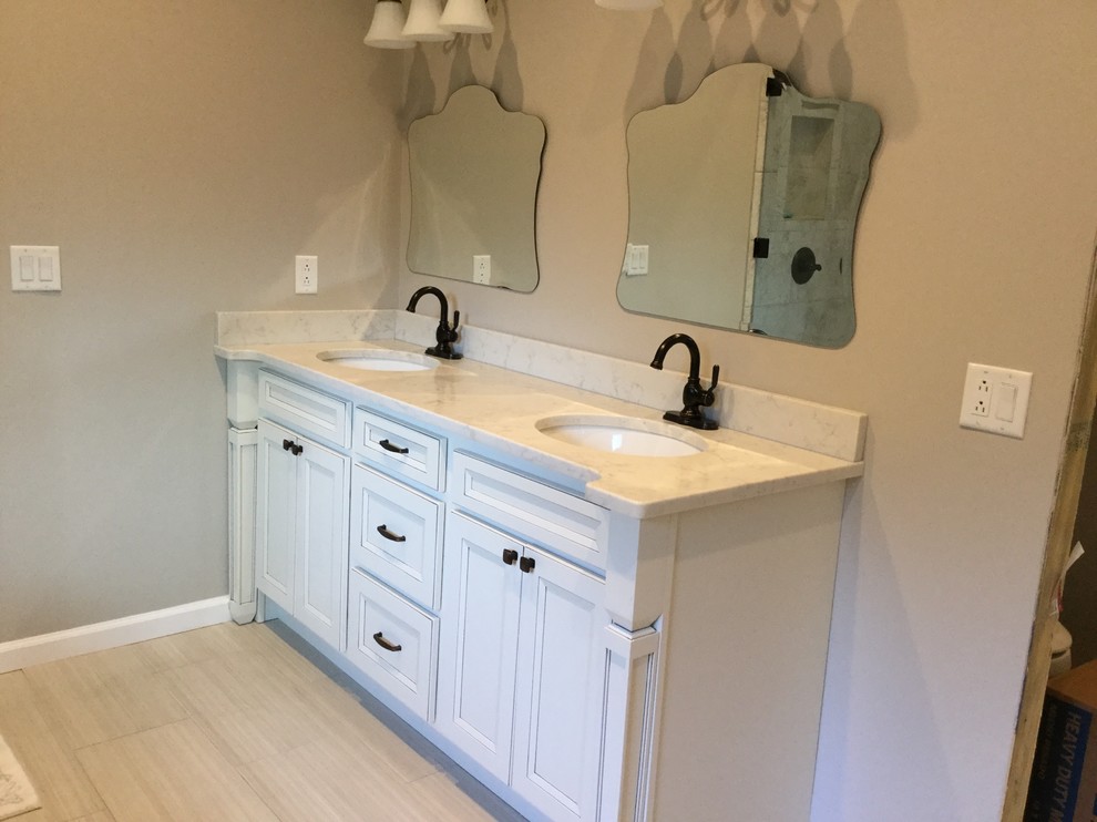 Photo of a large traditional master bathroom in Nashville with recessed-panel cabinets, white cabinets, grey walls, porcelain floors, an undermount sink, engineered quartz benchtops and beige floor.