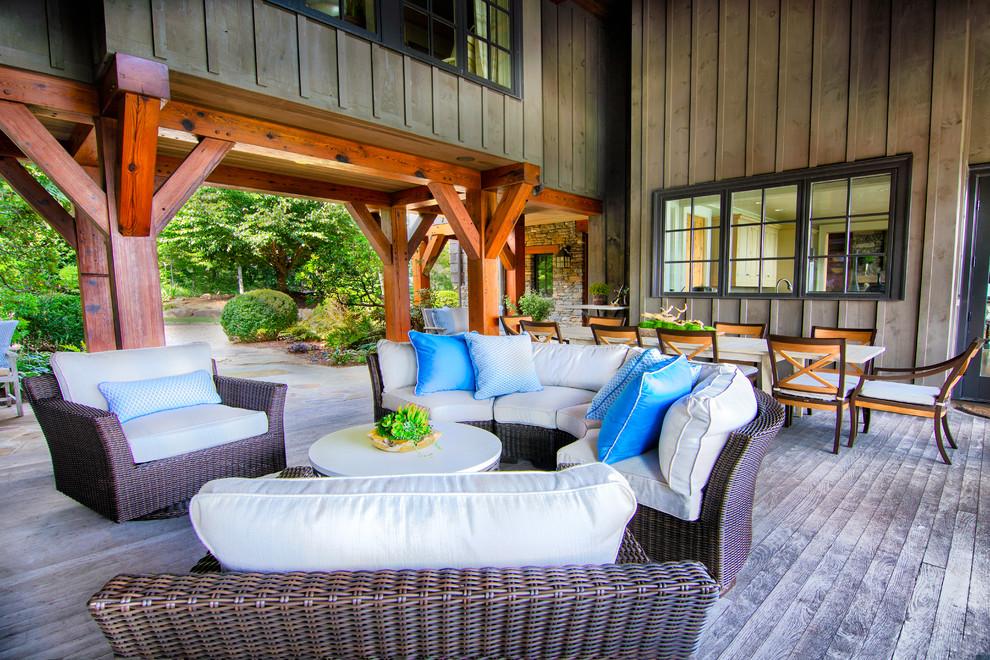 Inspiration for a large country backyard deck in DC Metro with with fireplace and a roof extension.