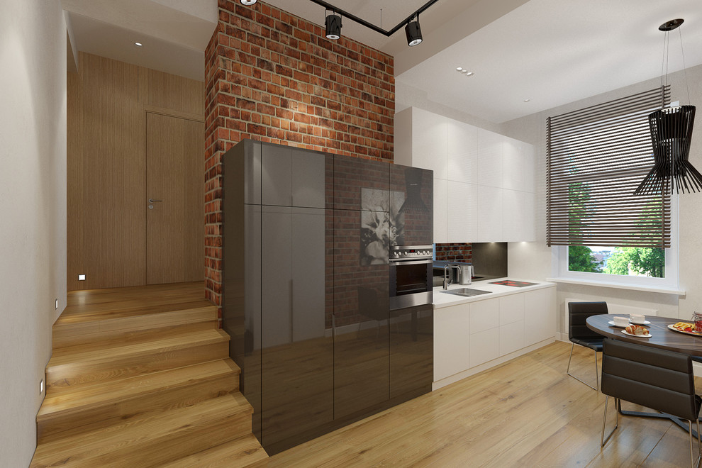 Inspiration for a mid-sized contemporary single-wall light wood floor eat-in kitchen remodel in London with a drop-in sink, flat-panel cabinets, white cabinets, glass tile backsplash and paneled appliances