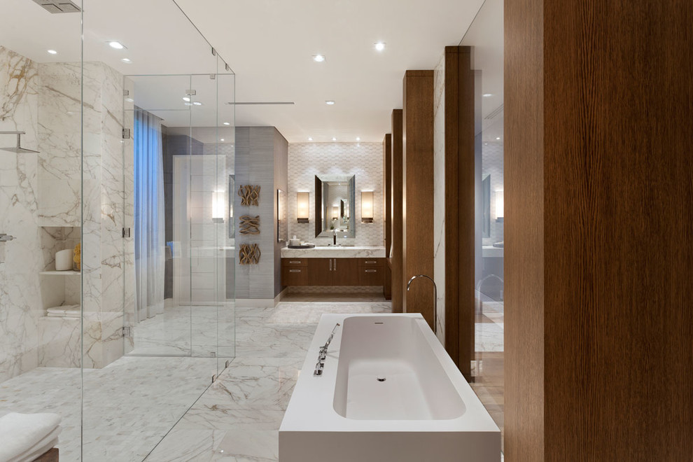 Inspiration for an expansive modern master bathroom in Miami with flat-panel cabinets, medium wood cabinets, a freestanding tub, a double shower, white tile, marble floors and marble benchtops.