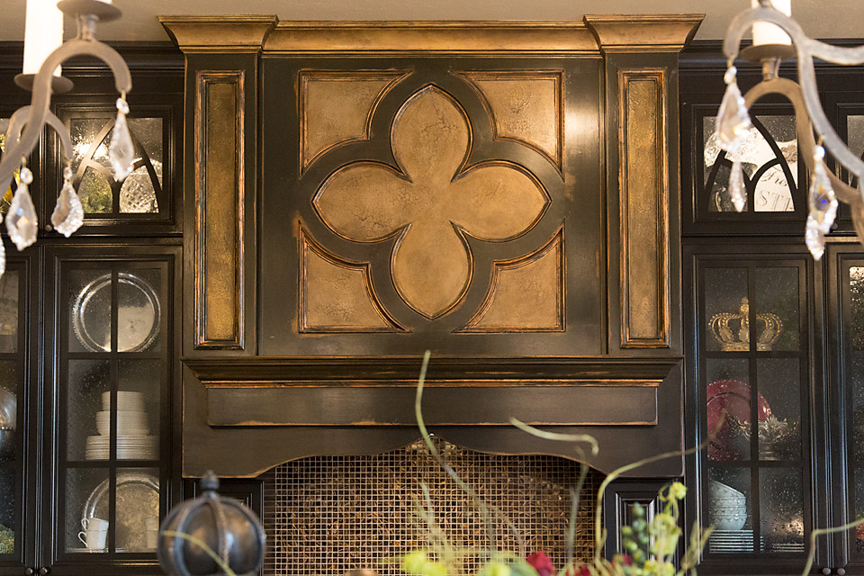 Open concept kitchen - large transitional open concept kitchen idea in Austin with black cabinets, glass-front cabinets, granite countertops and an island
