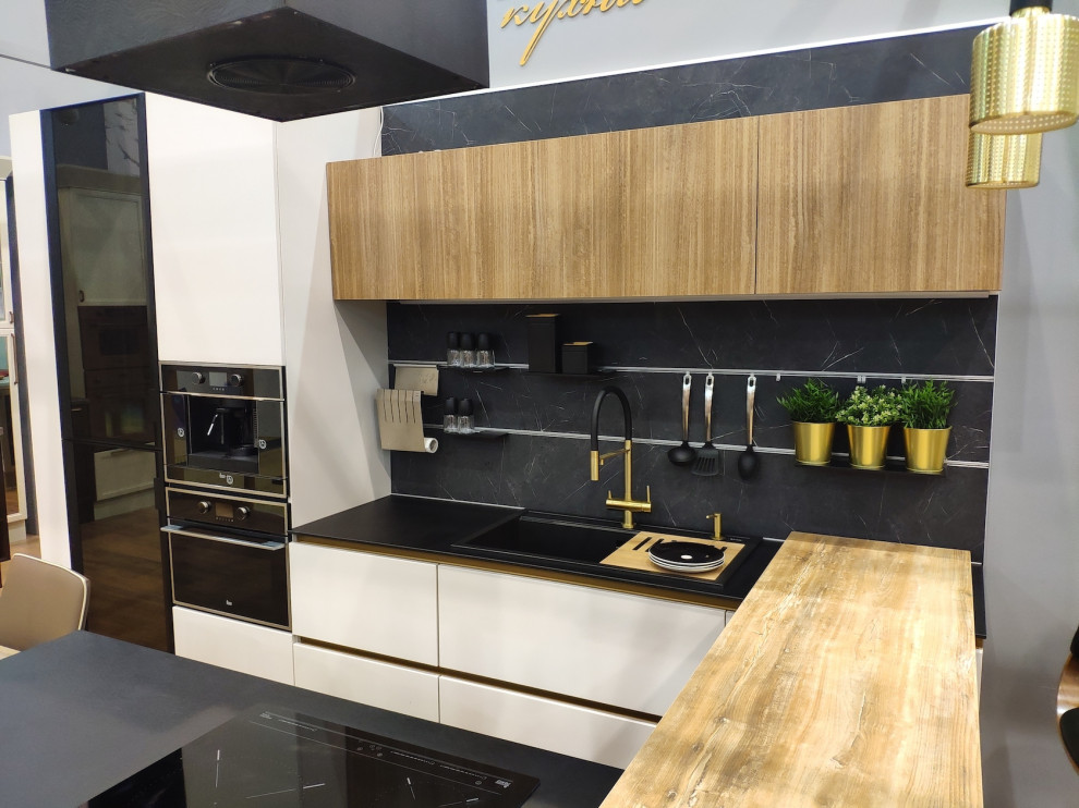 Medium sized contemporary u-shaped enclosed kitchen in Moscow with a double-bowl sink, flat-panel cabinets, medium wood cabinets, engineered stone countertops, grey splashback, engineered quartz splashback, black appliances, a breakfast bar and grey worktops.
