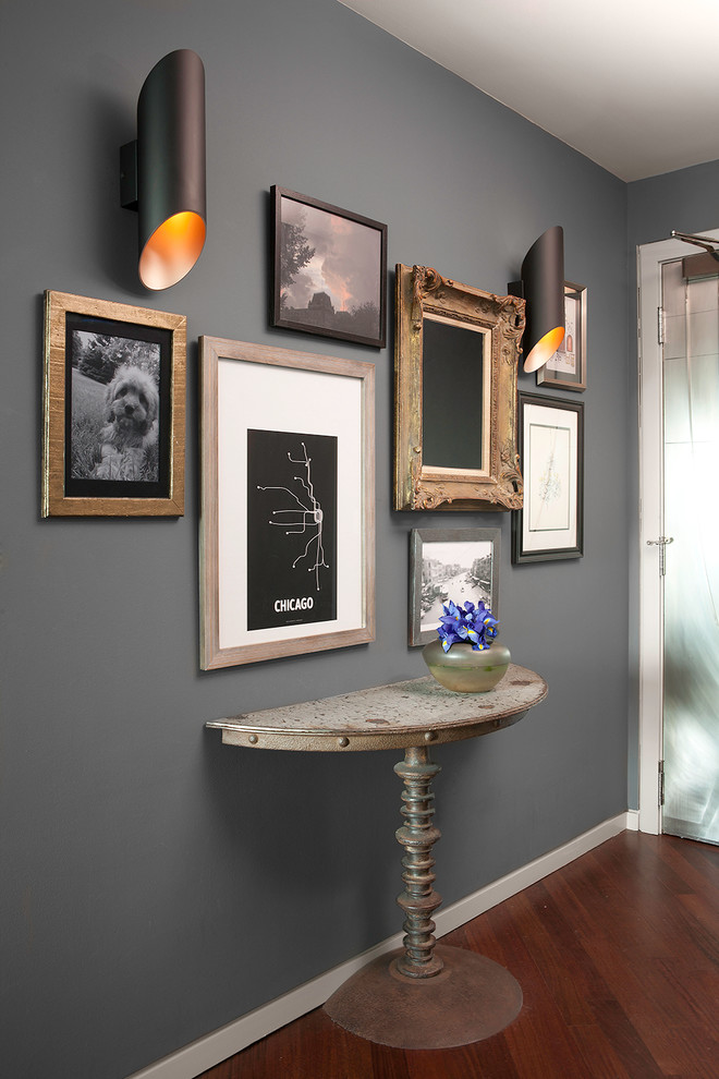 Example of a small transitional dark wood floor foyer design in Chicago with brown walls and a metal front door