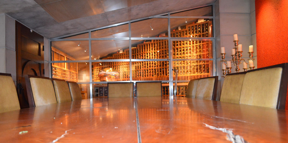 Inspiration for a large country wine cellar in San Diego with concrete floors and storage racks.