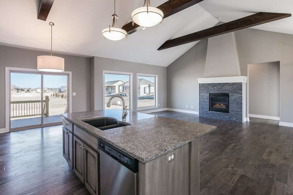 Photo of a mid-sized contemporary l-shaped eat-in kitchen in Wichita with an undermount sink, recessed-panel cabinets, white cabinets, granite benchtops, white splashback, ceramic splashback, stainless steel appliances, dark hardwood floors and with island.