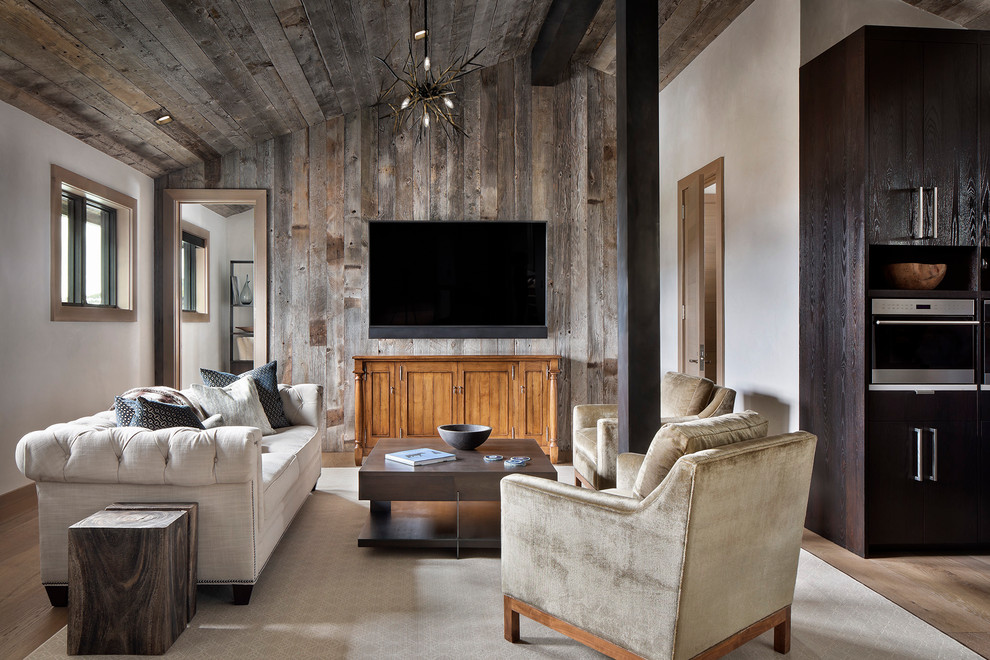 This is an example of a country open concept living room in Other with brown walls, medium hardwood floors, no fireplace, a wall-mounted tv and brown floor.