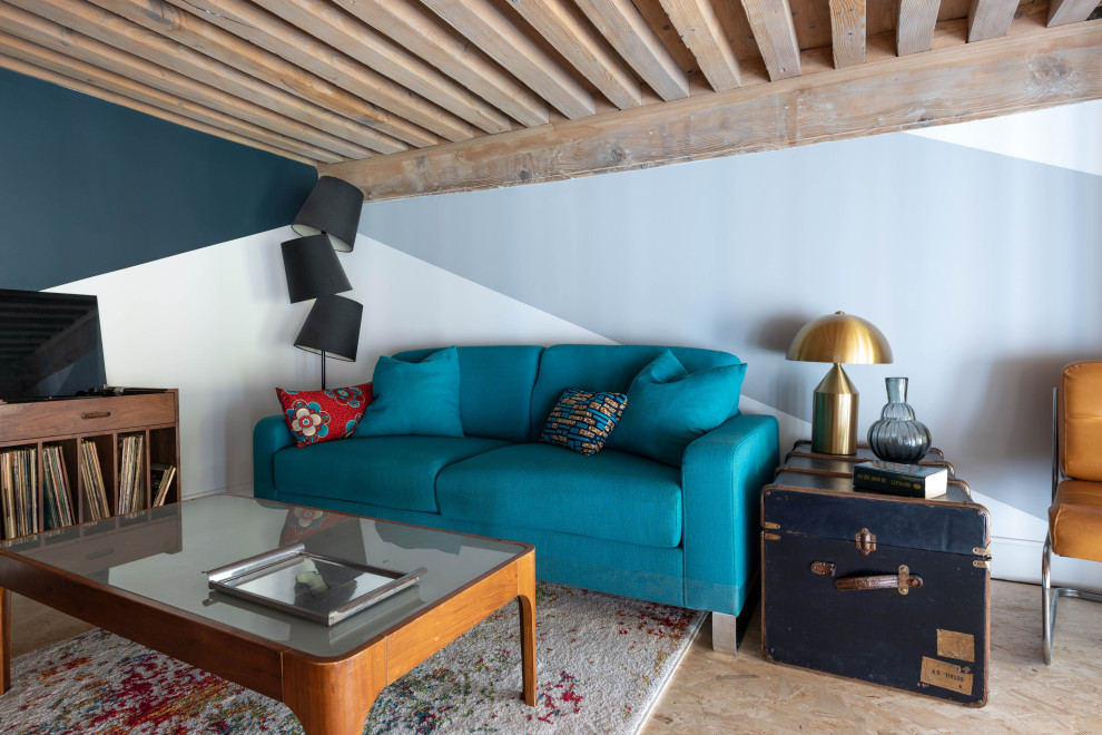 Photo of a medium sized open plan living room in Lyon with a concealed tv, exposed beams and feature lighting.