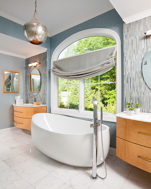Inspiration for a large contemporary master bathroom in New York with flat-panel cabinets, light wood cabinets, a freestanding tub, an alcove shower, blue tile, glass tile, blue walls, marble floors, an undermount sink, marble benchtops, white floor, a hinged shower door and turquoise benchtops.