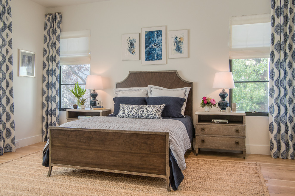 Example of a large transitional master light wood floor and brown floor bedroom design in Dallas with white walls and no fireplace
