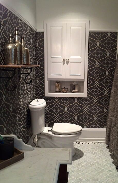Photo of a small traditional 3/4 bathroom in DC Metro with recessed-panel cabinets, white cabinets, a two-piece toilet, gray tile, mosaic tile, grey walls, mosaic tile floors and marble benchtops.