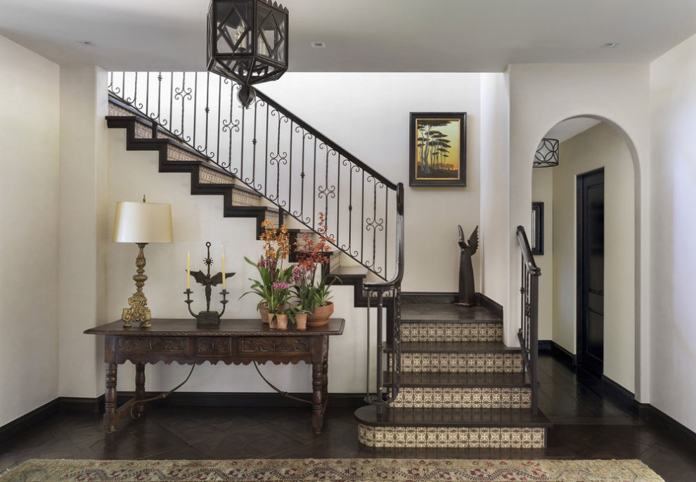 Design ideas for a mediterranean wood l-shaped staircase in Los Angeles with tile risers and metal railing.