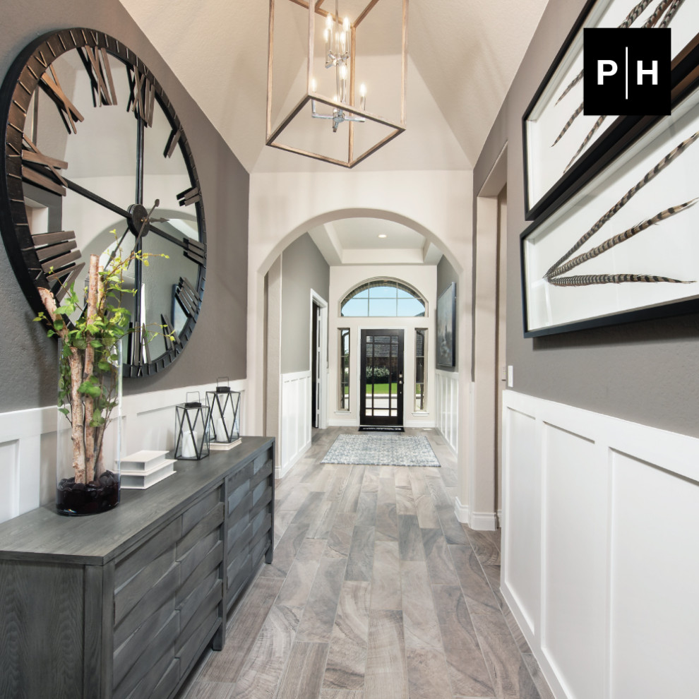 Inspiration for an entry hall in Other with grey walls, light hardwood floors, a single front door, a black front door, vaulted and decorative wall panelling.
