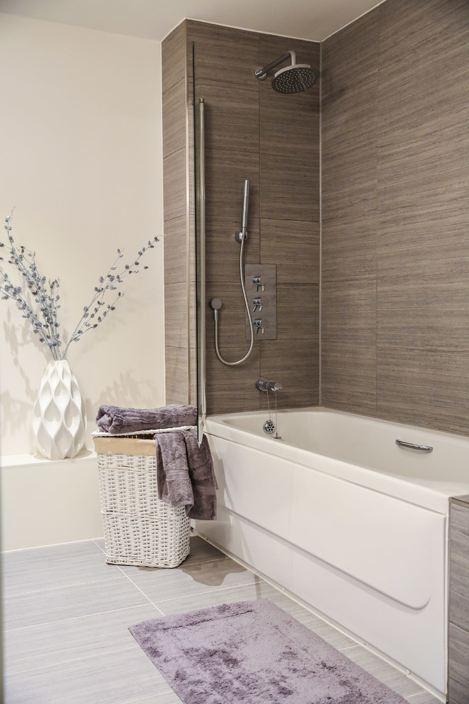 Inspiration for a contemporary master bathroom in London with gray tile and white walls.