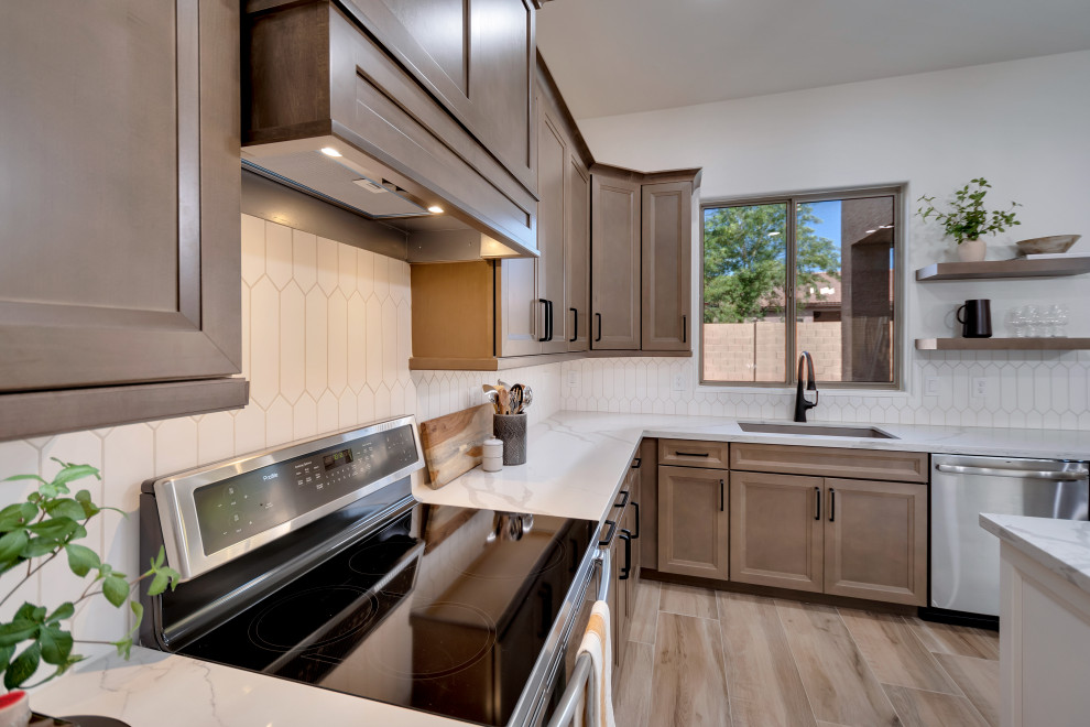 Eat-in kitchen - mid-sized transitional u-shaped ceramic tile and brown floor eat-in kitchen idea in Phoenix with beaded inset cabinets, brown cabinets, quartzite countertops, white backsplash, ceramic backsplash, an island and white countertops