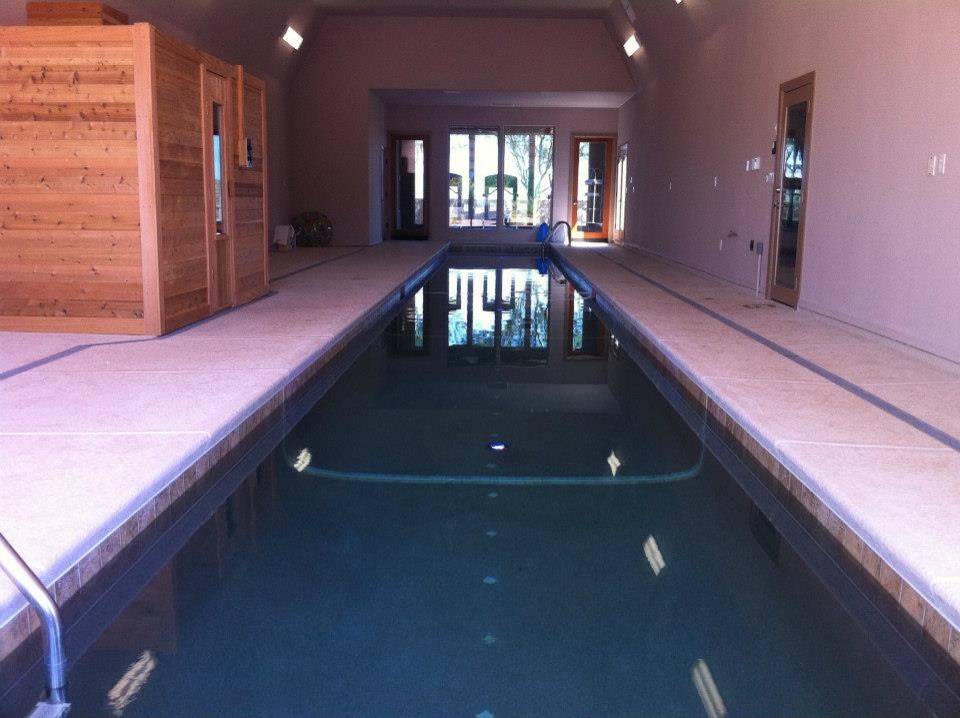Inspiration for a mid-sized rustic backyard stone and rectangular lap hot tub remodel in Los Angeles
