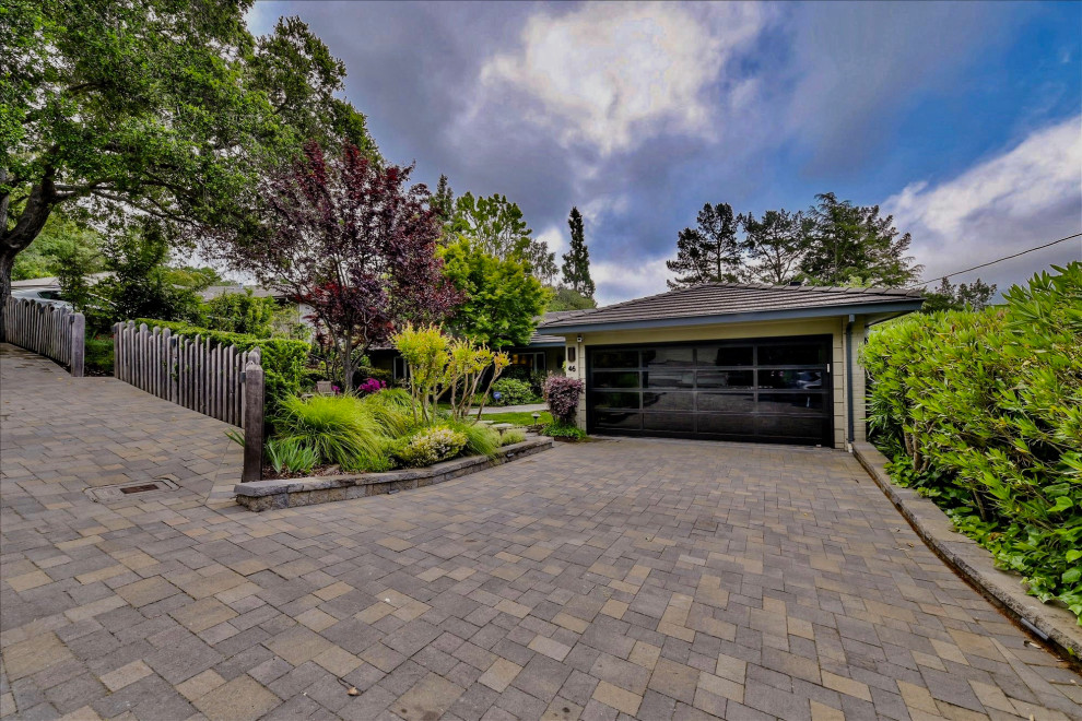 This is an example of a mid-sized arts and crafts front yard partial sun driveway in San Francisco with concrete pavers.