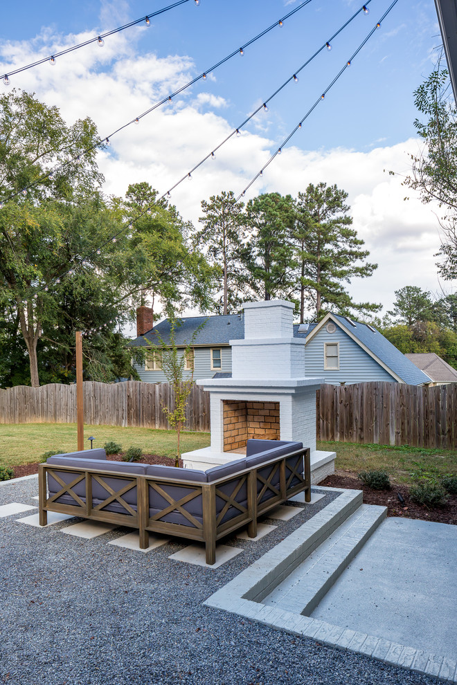 Transitional backyard patio in Raleigh with with fireplace, concrete pavers and no cover.