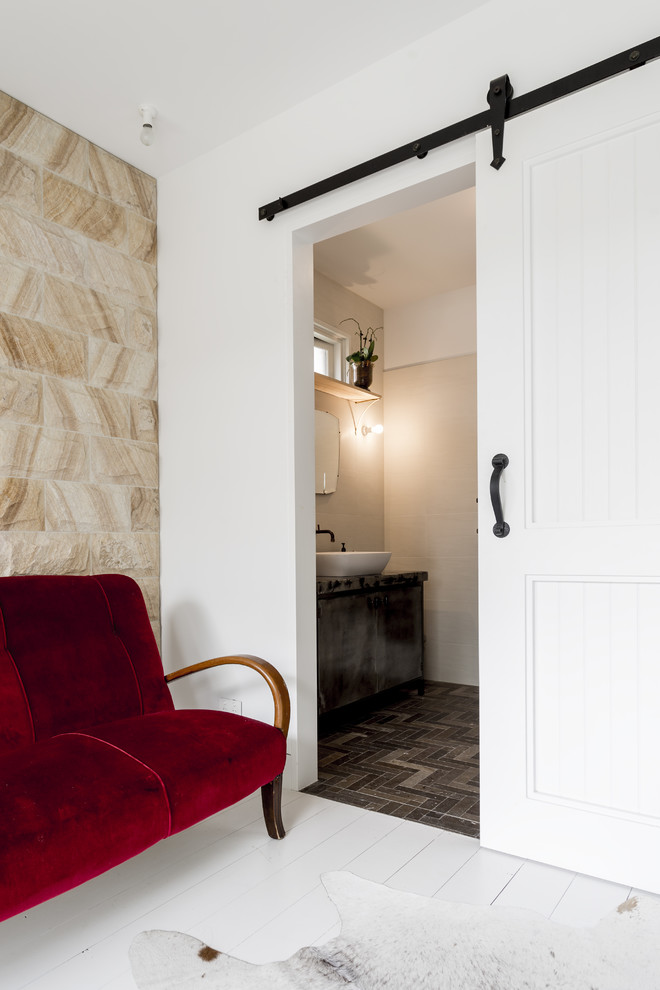 Design ideas for a mid-sized mediterranean 3/4 bathroom in Sunshine Coast with flat-panel cabinets, distressed cabinets, a freestanding tub, a one-piece toilet, grey walls, ceramic floors, an integrated sink, marble benchtops, grey floor and beige benchtops.