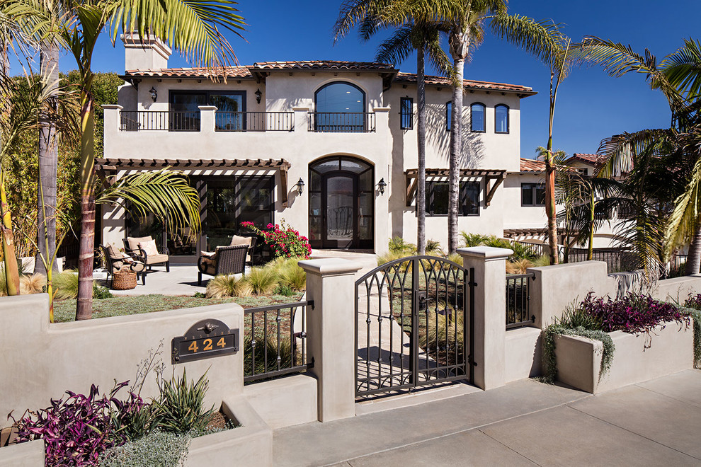 Inspiration for an expansive mediterranean two-storey stucco beige exterior in San Diego.