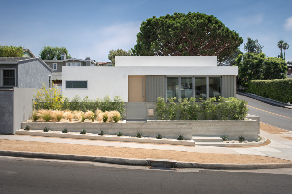 Modern one-storey stucco white house exterior in Los Angeles with a shed roof.
