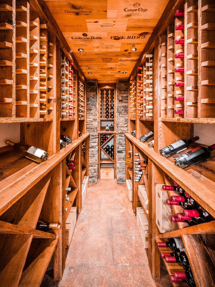 Design ideas for a beach style wine cellar in New York with storage racks and brown floor.