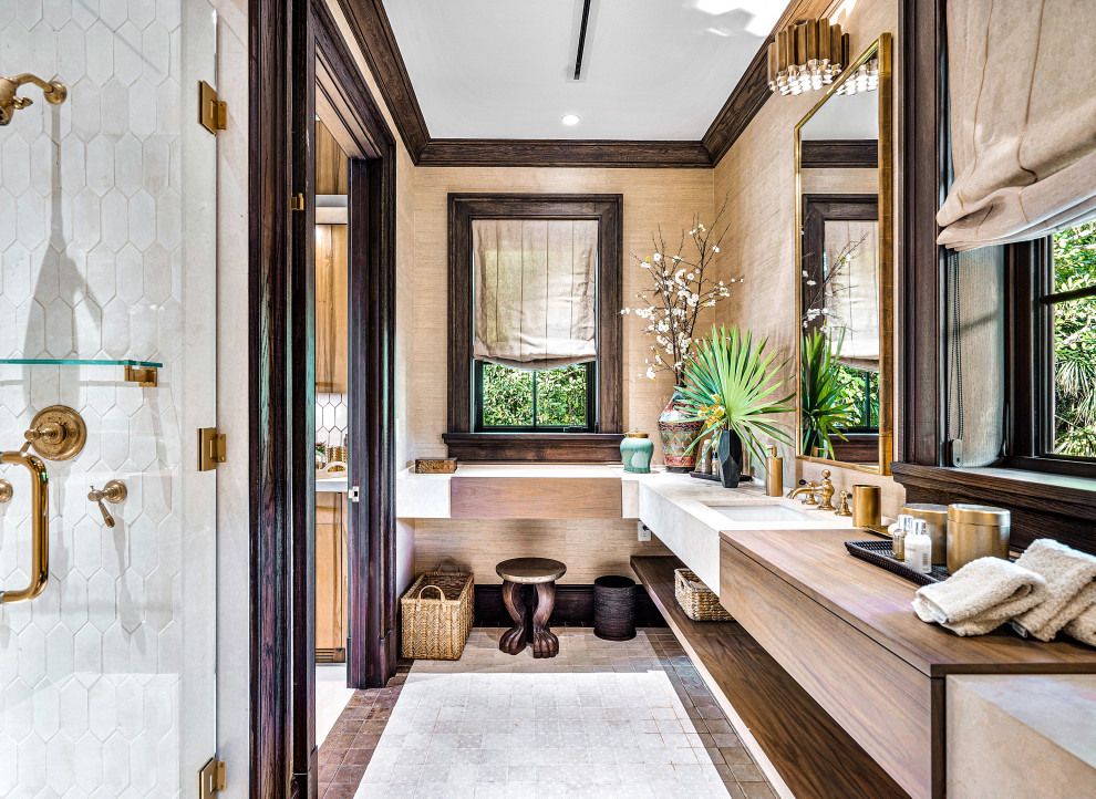 Photo of an expansive transitional wet room bathroom in Miami with flat-panel cabinets, dark wood cabinets, a one-piece toilet, white tile, terra-cotta tile, beige walls, terra-cotta floors, an undermount sink, limestone benchtops, beige floor, a hinged shower door, grey benchtops, an enclosed toilet, a double vanity, a floating vanity and wallpaper.