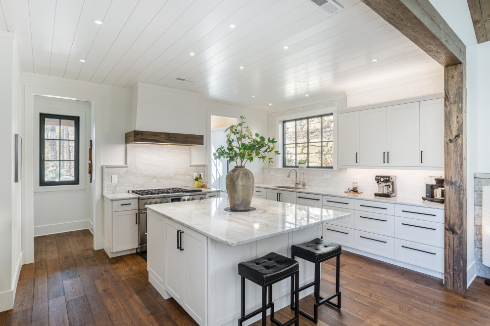 Kitchen - rustic dark wood floor, brown floor and wood ceiling kitchen idea with an undermount sink, shaker cabinets, white cabinets, quartzite countertops, white backsplash, stone slab backsplash, stainless steel appliances, an island and white countertops