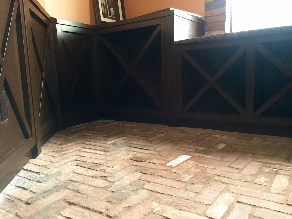 Example of a mid-sized mountain style brick floor wine cellar design with diamond bins