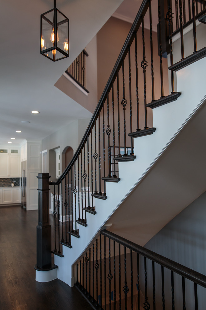 This is an example of a large transitional wood straight staircase in Chicago with painted wood risers.