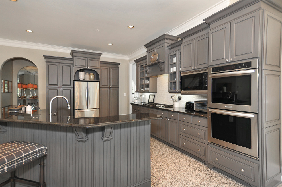 Inspiration for a mid-sized traditional u-shaped kitchen pantry in Atlanta with a drop-in sink, raised-panel cabinets, grey cabinets, granite benchtops, grey splashback, stone tile splashback, stainless steel appliances, marble floors and with island.