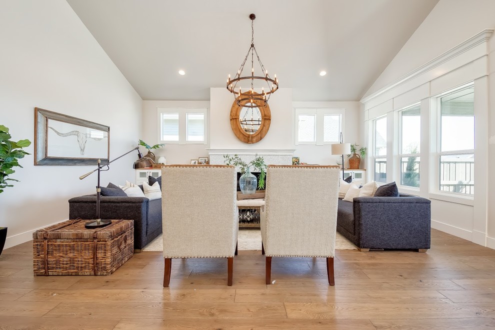 Inspiration for a large contemporary dining room in Boise with white walls, medium hardwood floors, a ribbon fireplace, a tile fireplace surround and brown floor.