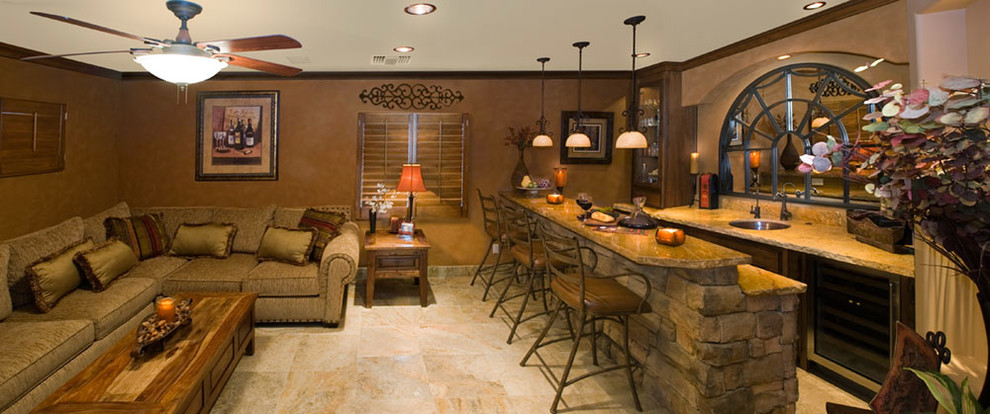 Seated home bar - large rustic galley slate floor and beige floor seated home bar idea in Phoenix with an undermount sink, recessed-panel cabinets, dark wood cabinets, soapstone countertops, beige backsplash, stone slab backsplash and beige countertops