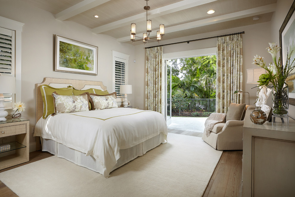 Photo of a mid-sized beach style bedroom in Other with beige walls and medium hardwood floors.