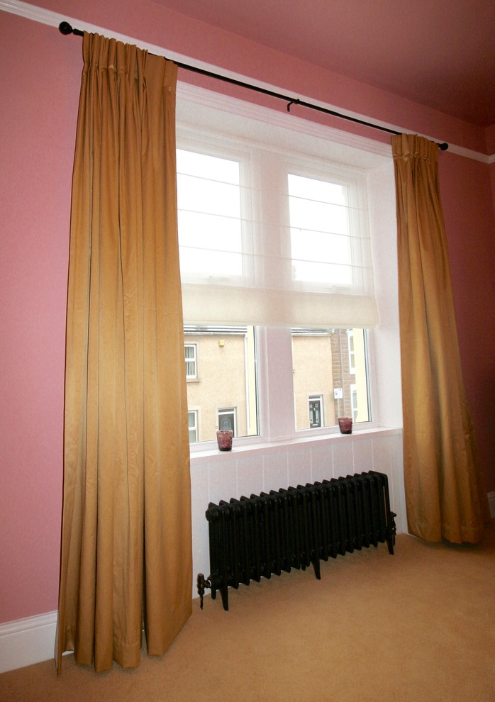 Large eclectic master bedroom in Other with pink walls, carpet, a standard fireplace and a plaster fireplace surround.