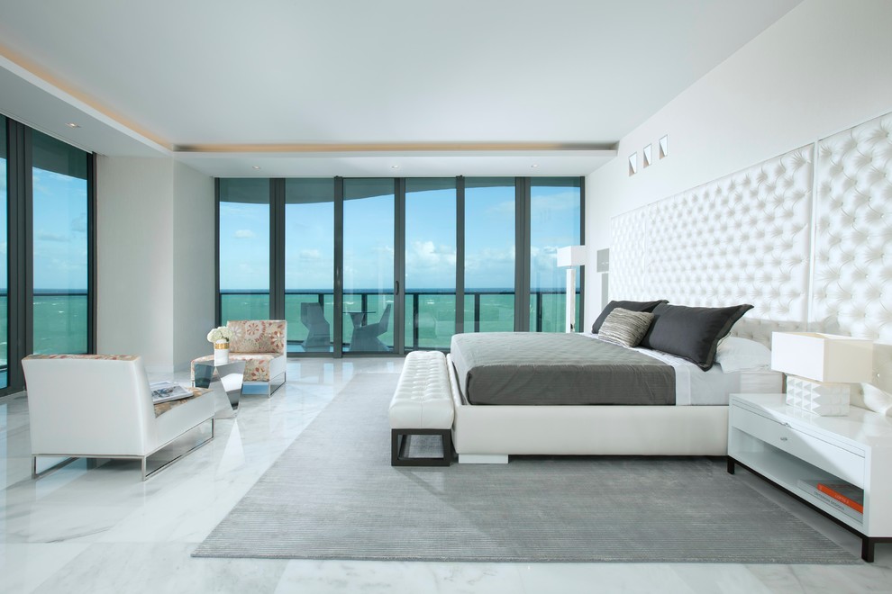 Inspiration for an expansive contemporary master bedroom in Miami with white walls and marble floors.