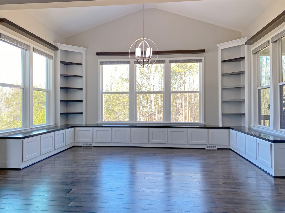 Large arts and crafts kitchen/dining combo in Raleigh with dark hardwood floors.
